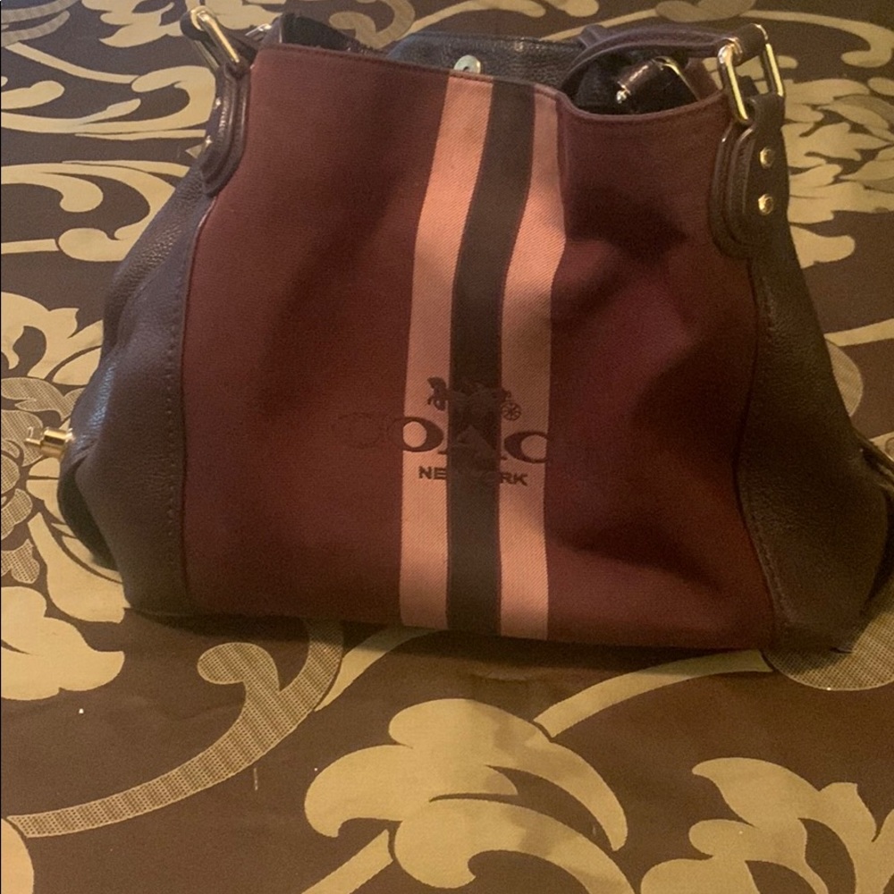Coach multi colored purse with secured clasp